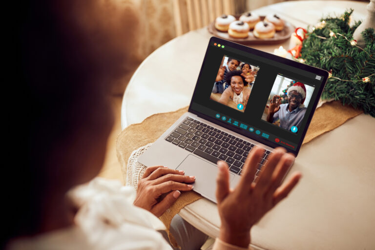 Close-up of African American gathering via video call over laptop on Christmas day.