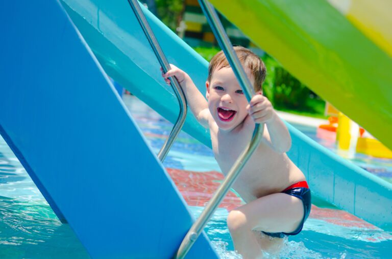 happy-boy-climbing-water-slide-in-the-aqua-park-2024-12-07-01-02-47-utc